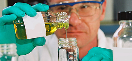 scientist pouring oil