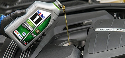 Mobil1 oil being poured into car